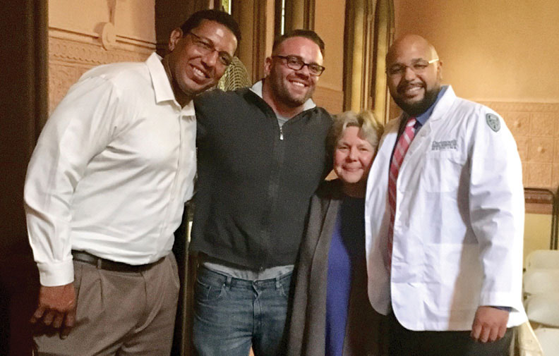 Chad Lewis '20 (right) with (left to right) Dr. Alonzo Grant, Paul
Risotti, and his mom at Geisel's White Coat Ceremony last fall